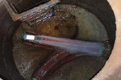 Close-up of a sensor in a wastewater tank, used for monitoring and control of water quality.