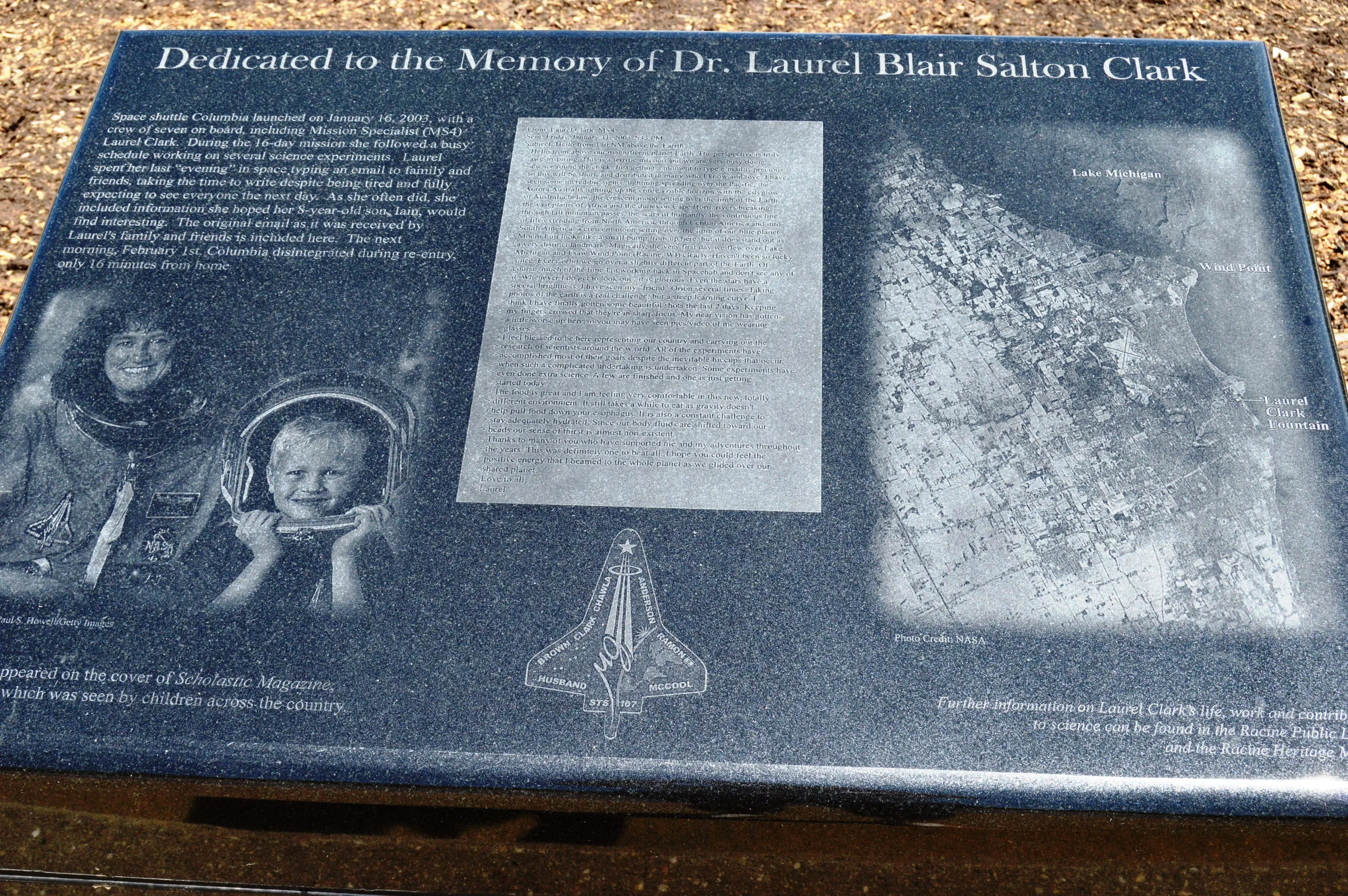 Memorial plaque dedicated to Dr. Laurel Blair Salton Clark, featuring photos, text, and a map.