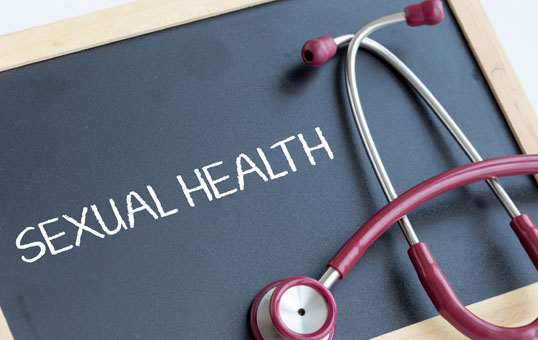 Sexual Health written on a chalkboard with a stethoscope draped over it.