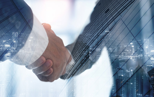 Handshake between two people, superimposed over a cityscape, symbolizing partnership and business agreement.