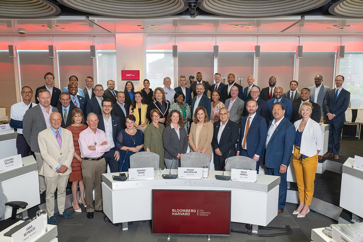 Large group of diverse business leaders pose for a photo at a Business Forward event.