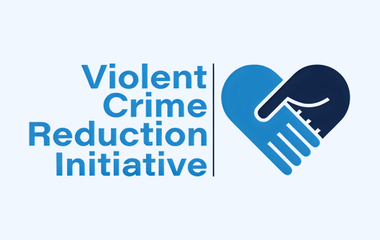 Violent Crime Reduction Initiative logo: text beside a blue heart formed by two hands shaking.