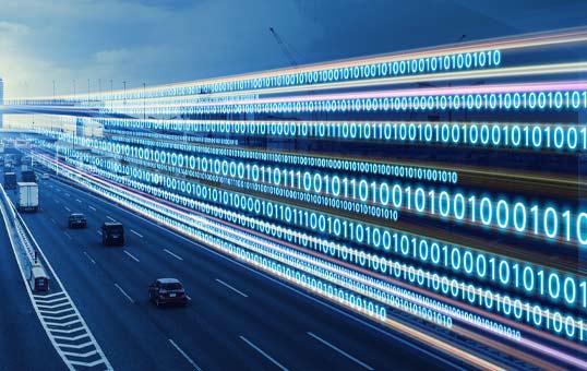 Highway with cars overlaid with binary code, representing data transmission or autonomous vehicles.