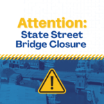 Attention: State Street Bridge Closure. Yellow caution sign with bridge background. Sign warns of bridge closure.