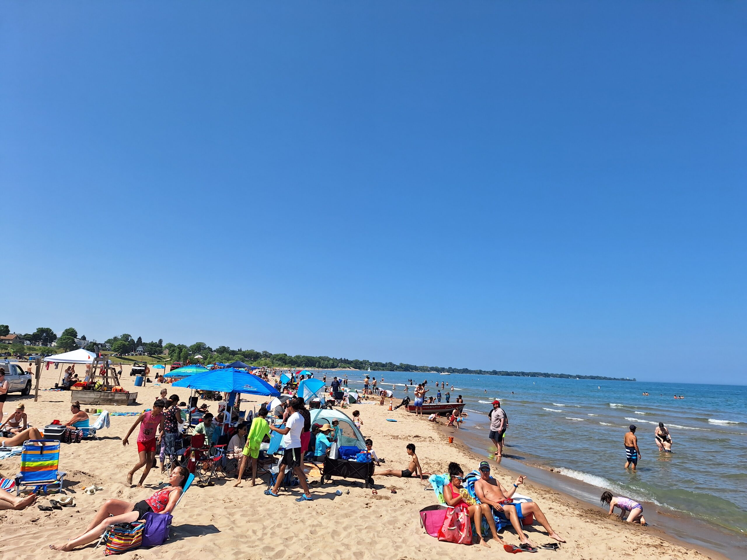 Image of People at North Beach Enjoying a Summer Day. Features People and Water.